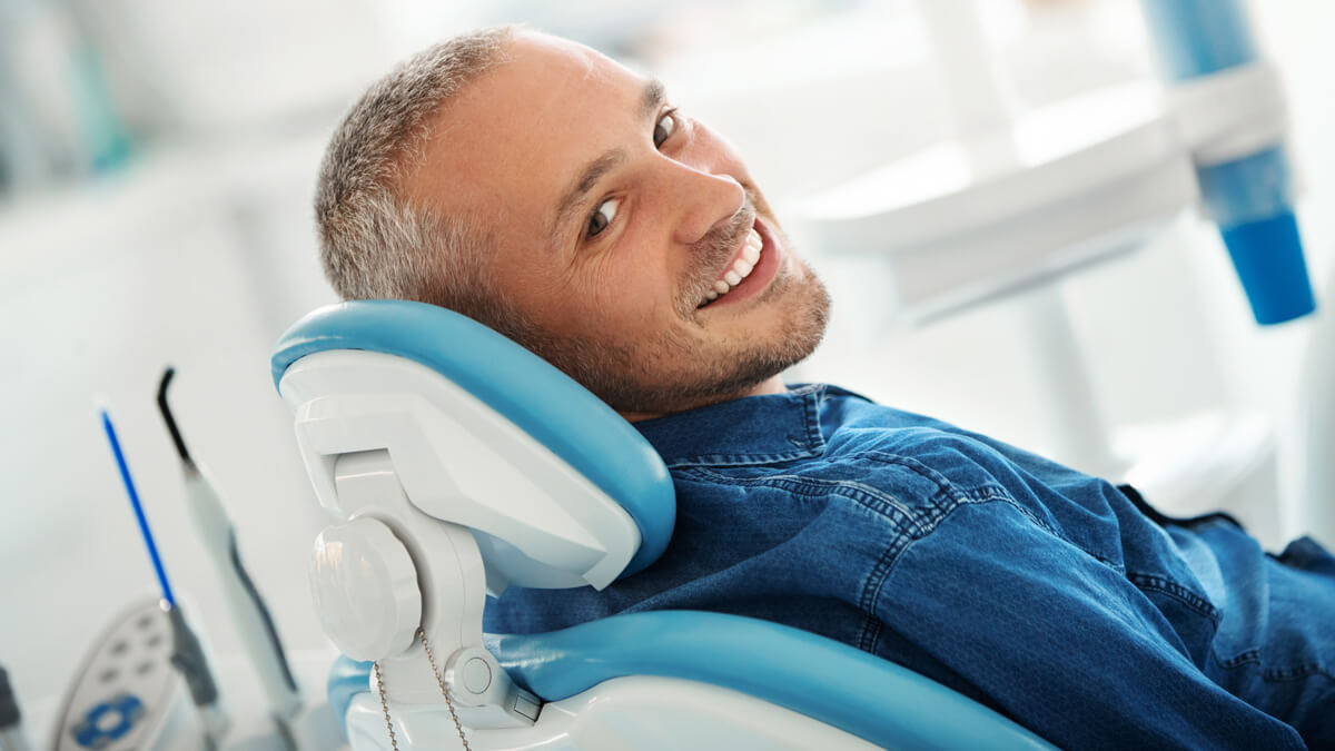 man-smiling-in-dental-chair-wide