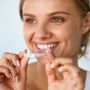 woman-smiling-with-clear-aligner-sq-300